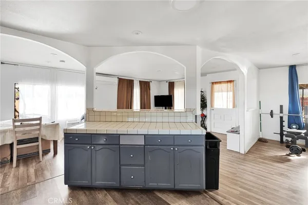 a living room with granite countertop furniture and wooden floor