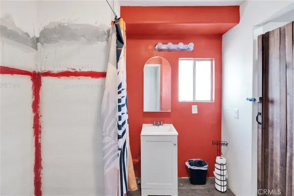 a bathroom with a toilet sink and shower curtain