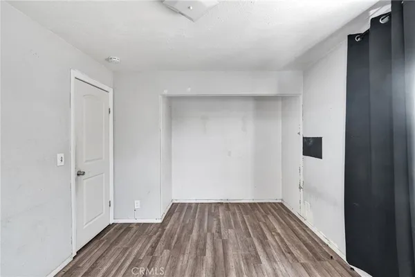 a view of a room with wooden floor