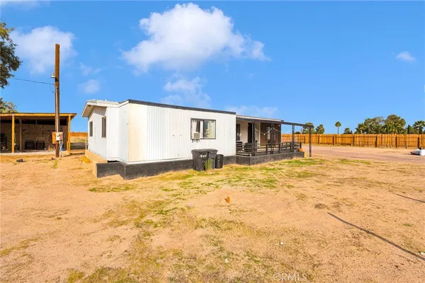 a backyard of a house with basket ball court