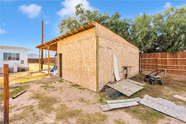 a view of backyard with a patio