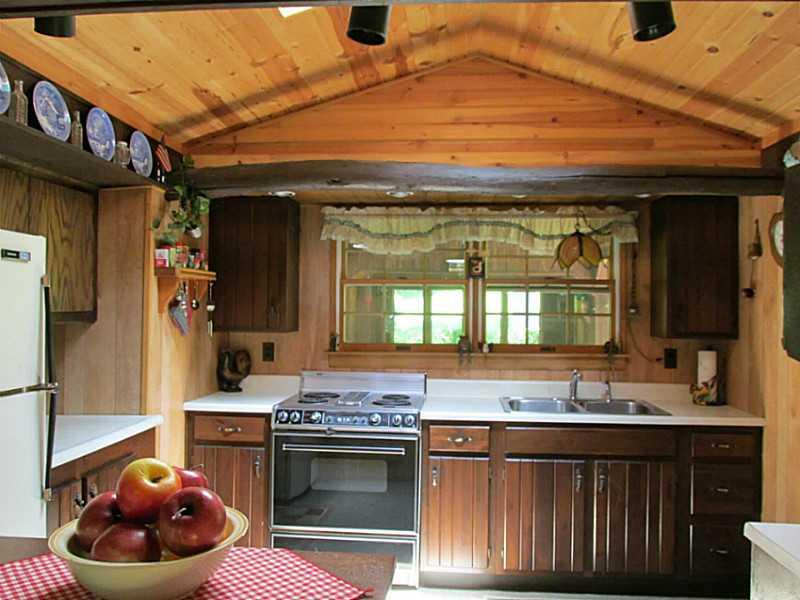 157 Cabin Road Normalville, PA 15469 - Photo 16 of 25 Kitchen. That s a Jenn-Aire stove. There s a door to the right. The pavilion is outside the windows,