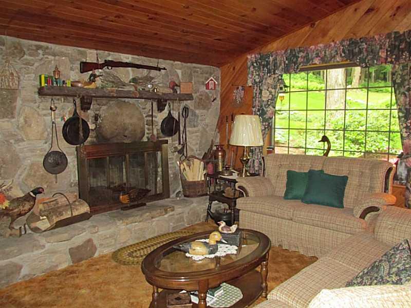 157 Cabin Road Normalville, PA 15469 - Photo 17 of 25 Living Room. Stone faced wood burning fireplace