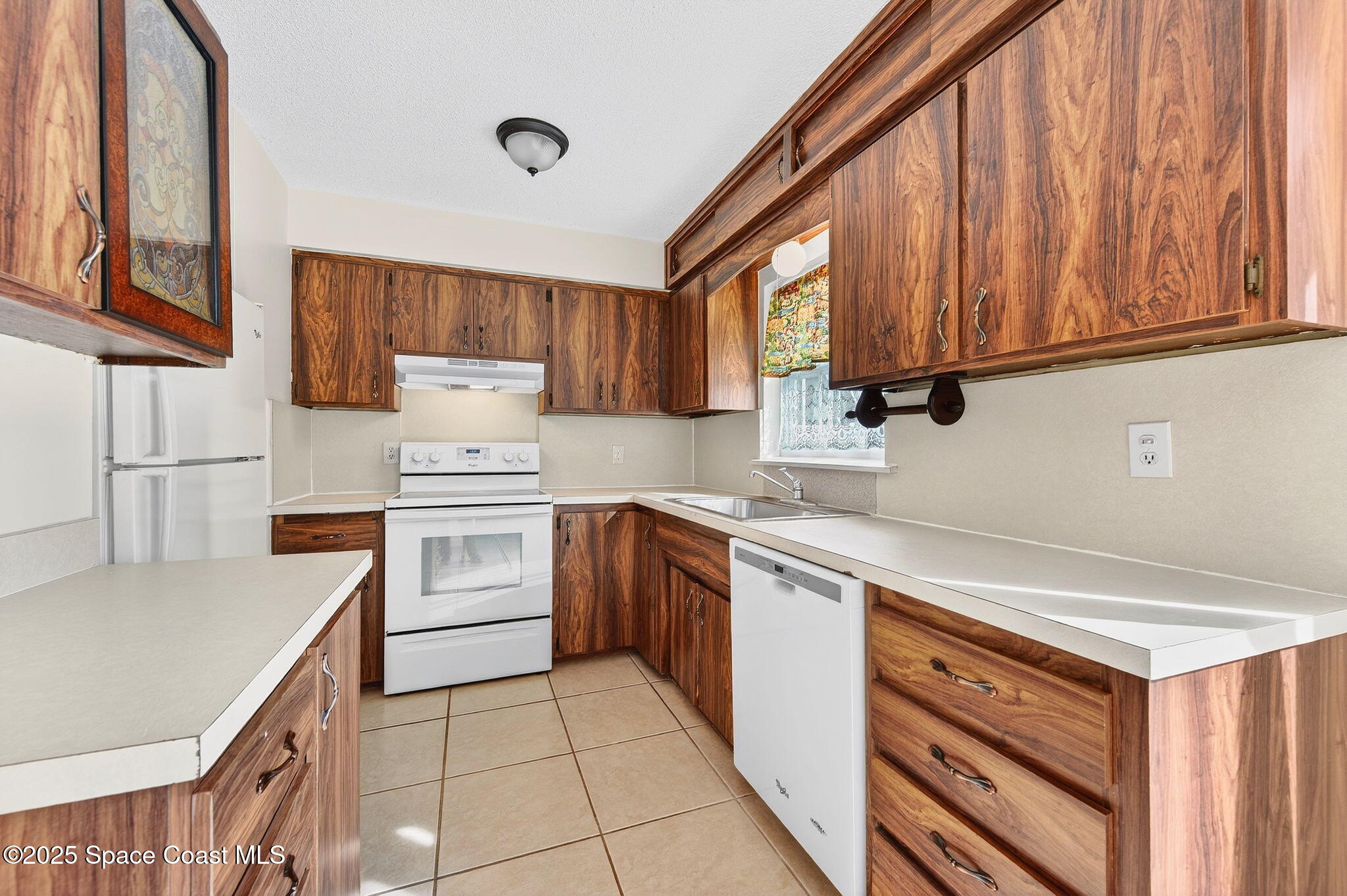 2135 Otterbein Avenue Cocoa, FL 32926 - Photo 13 of 28 a kitchen with a stove cabinets and a sink