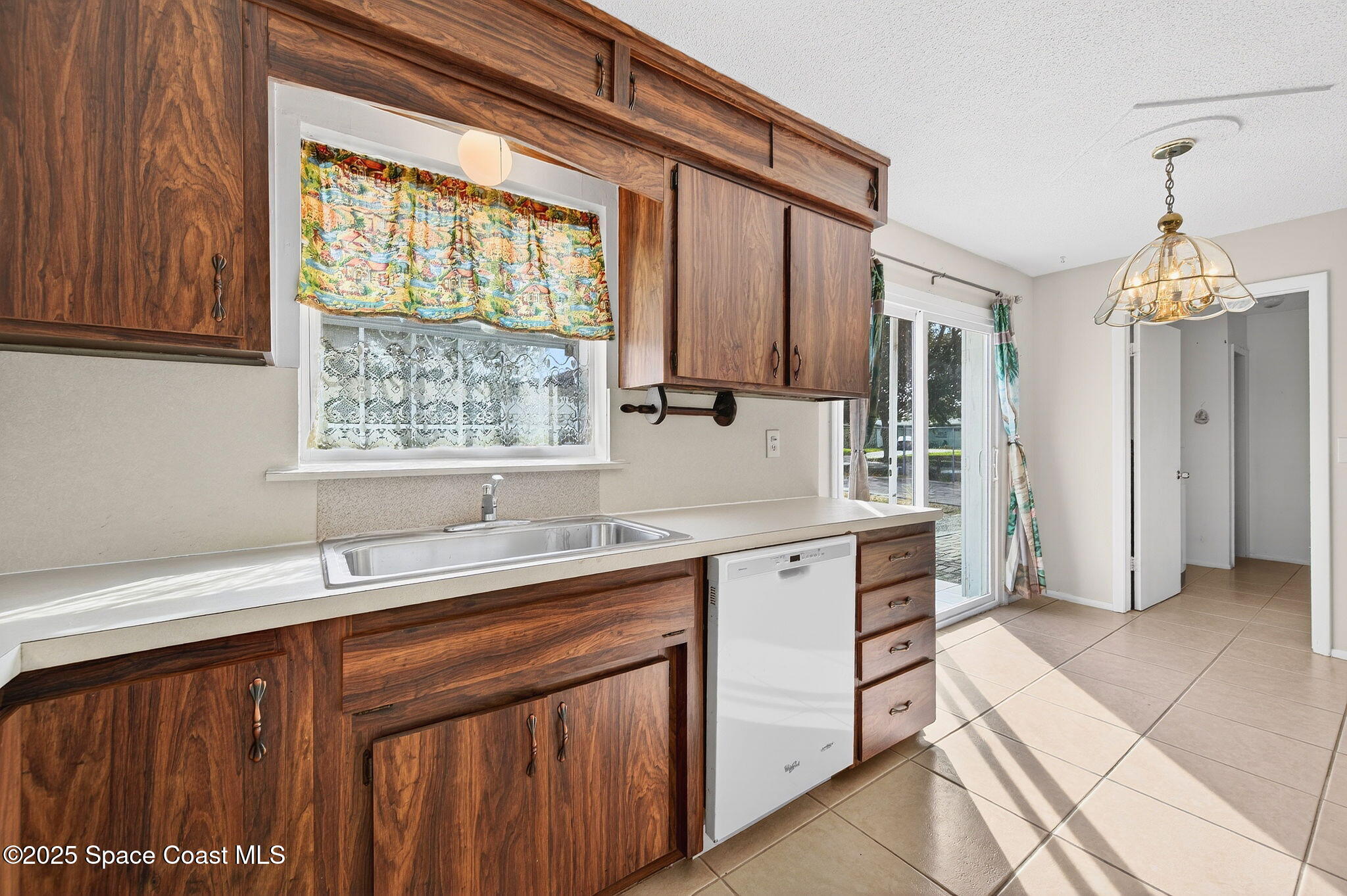 2135 Otterbein Avenue Cocoa, FL 32926 - Photo 15 of 28 a kitchen that has a sink and a stove in it