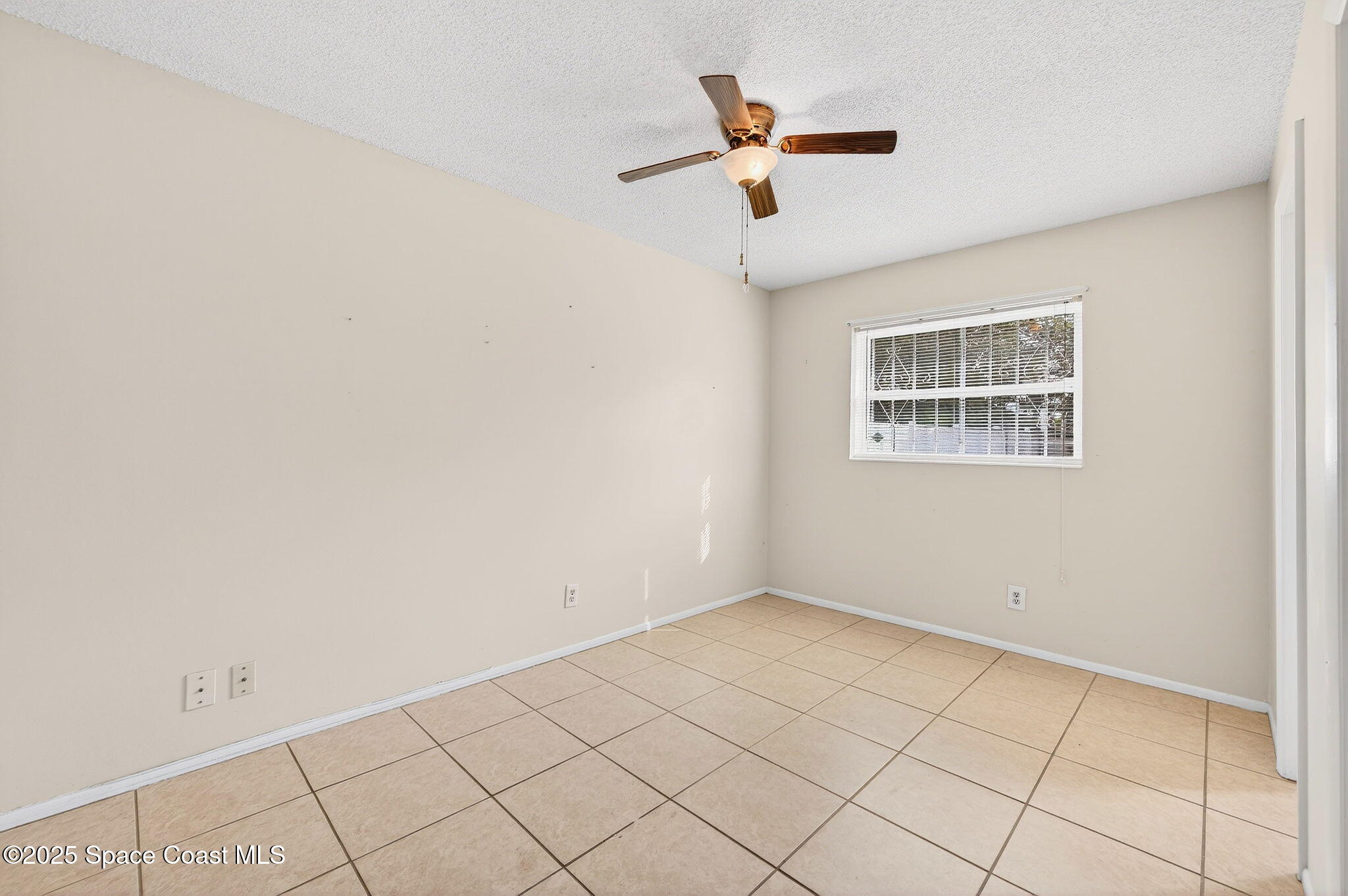 2135 Otterbein Avenue Cocoa, FL 32926 - Photo 16 of 28 an empty room with a window