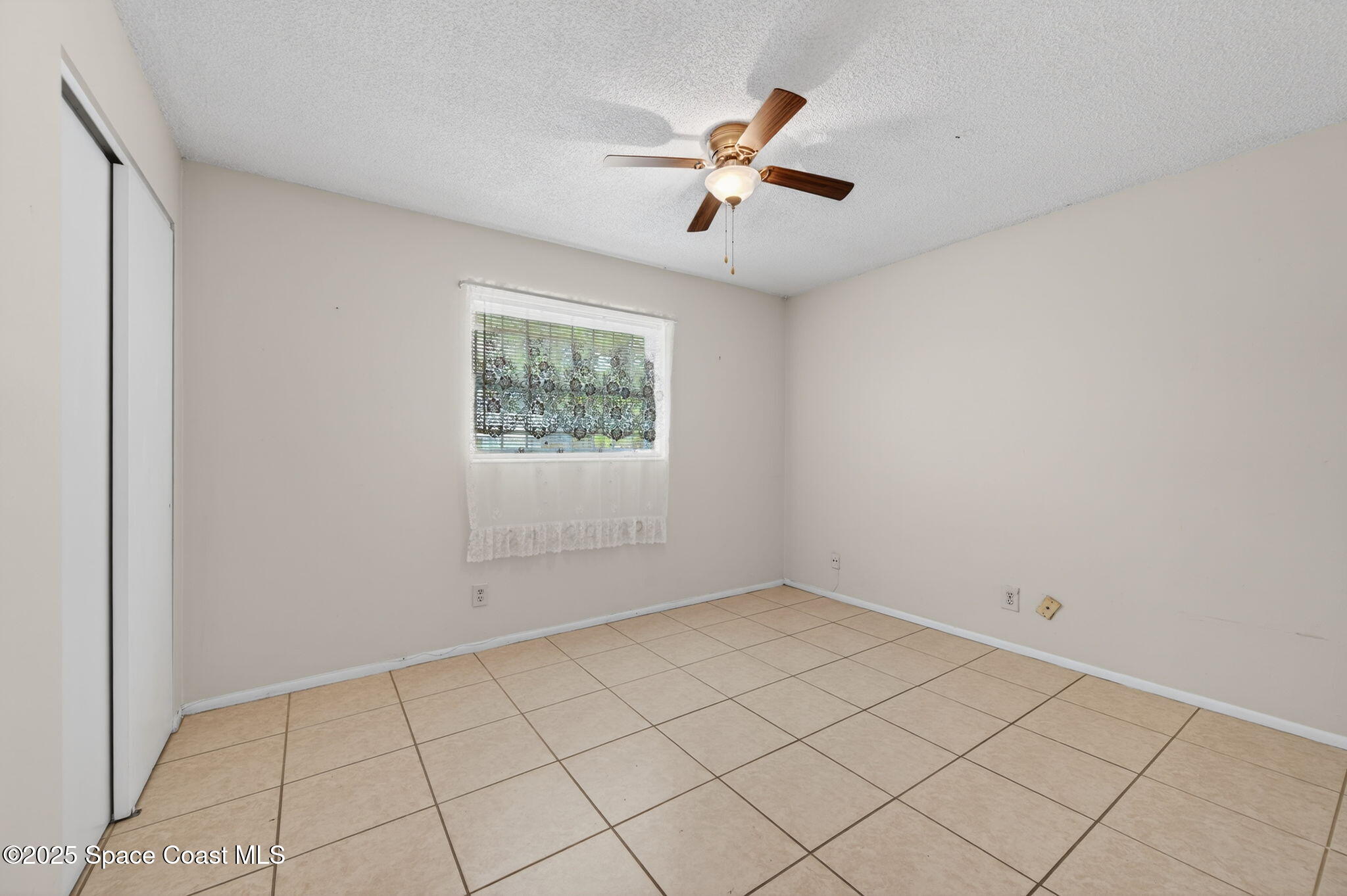 2135 Otterbein Avenue Cocoa, FL 32926 - Photo 20 of 28 an empty room with windows and fan
