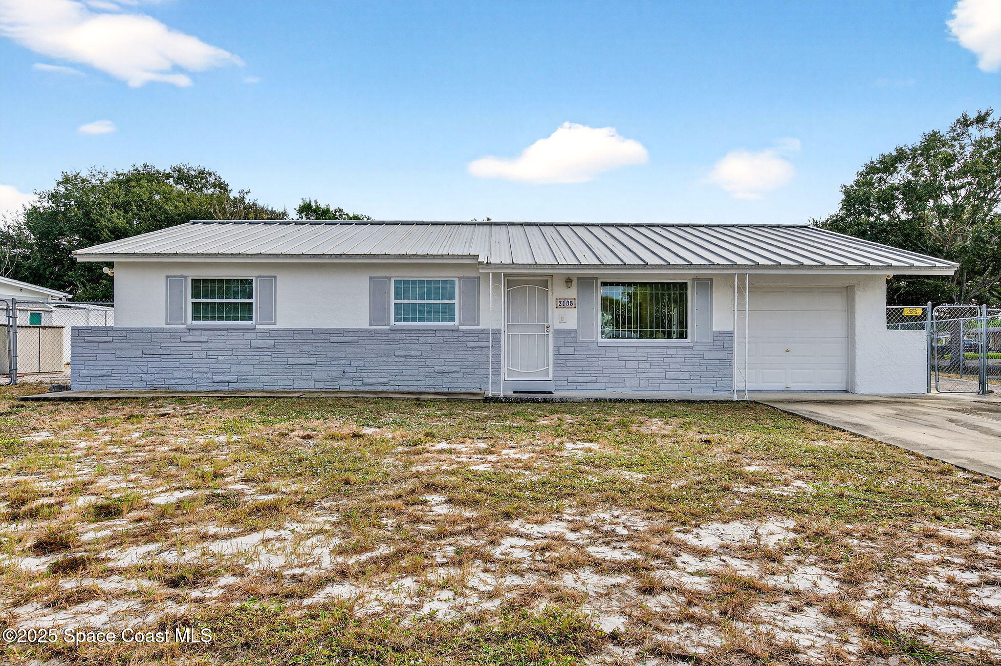 2135 Otterbein Avenue Cocoa, FL 32926 - Photo 4 of 28 a front view of a house with a garden