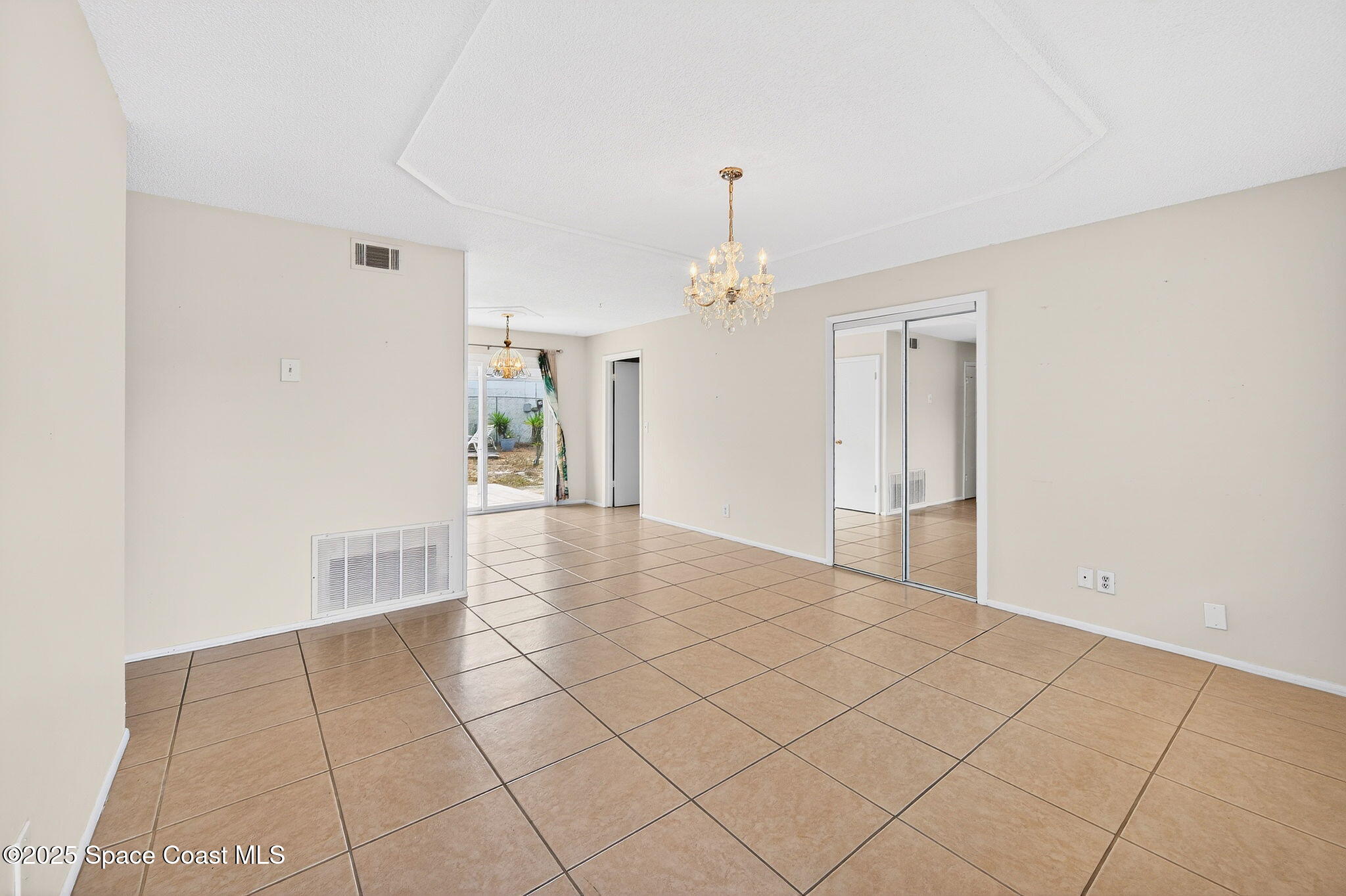 2135 Otterbein Avenue Cocoa, FL 32926 - Photo 7 of 28 a view of a livingroom with wooden floor and chandelier
