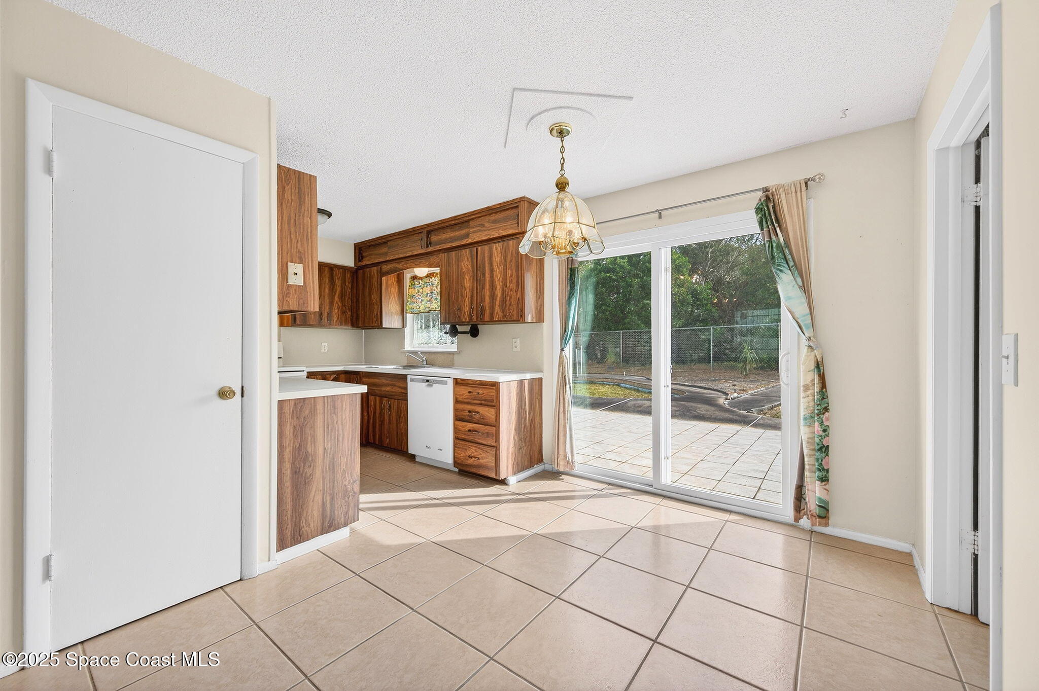 2135 Otterbein Avenue Cocoa, FL 32926 - Photo 10 of 28 a open kitchen with kitchen island granite countertop a refrigerator and a sink