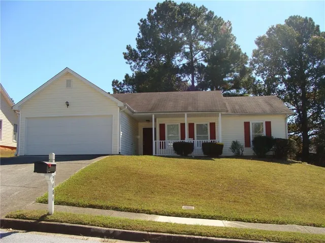 a view of house with yard