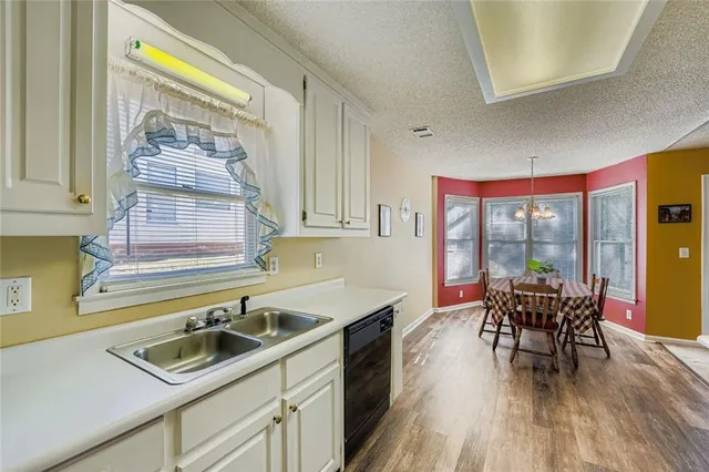 a kitchen with a table chairs sink and cabinets