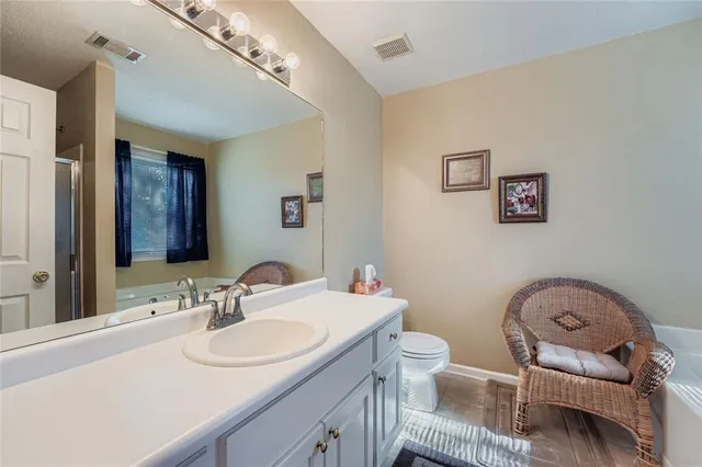 a bathroom with a sink toilet and a mirror