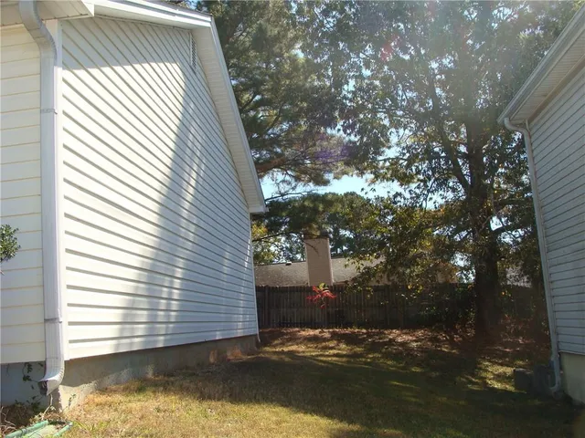 a view of house with backyard