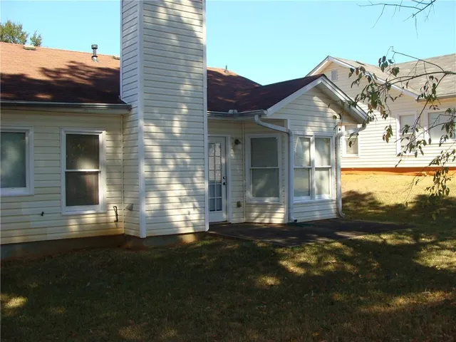 a view of house with backyard