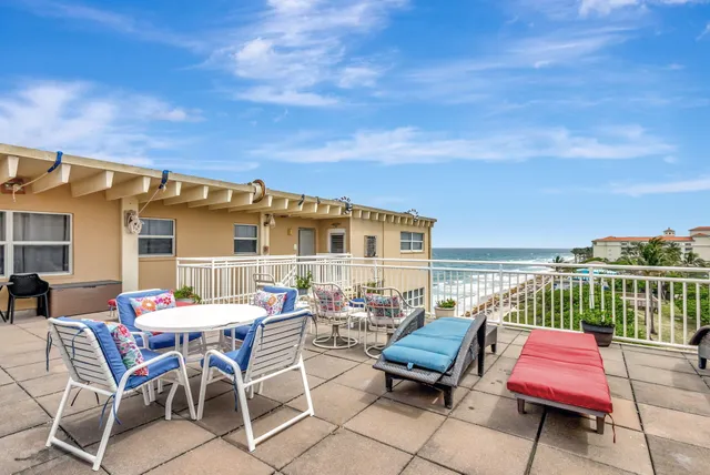 a roof deck with a table and chairs