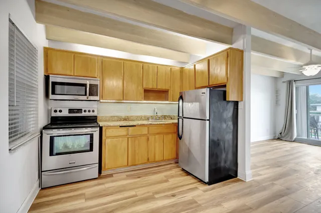 a kitchen with a refrigerator stove and microwave