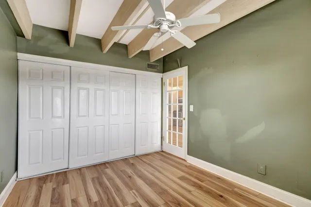 an empty room with a ceiling fan