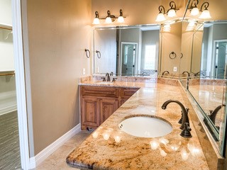 1306 Keenland Road Corpus Christi, TX 78418 - Photo 23 of 26 a bathroom with a granite countertop sink and a mirror