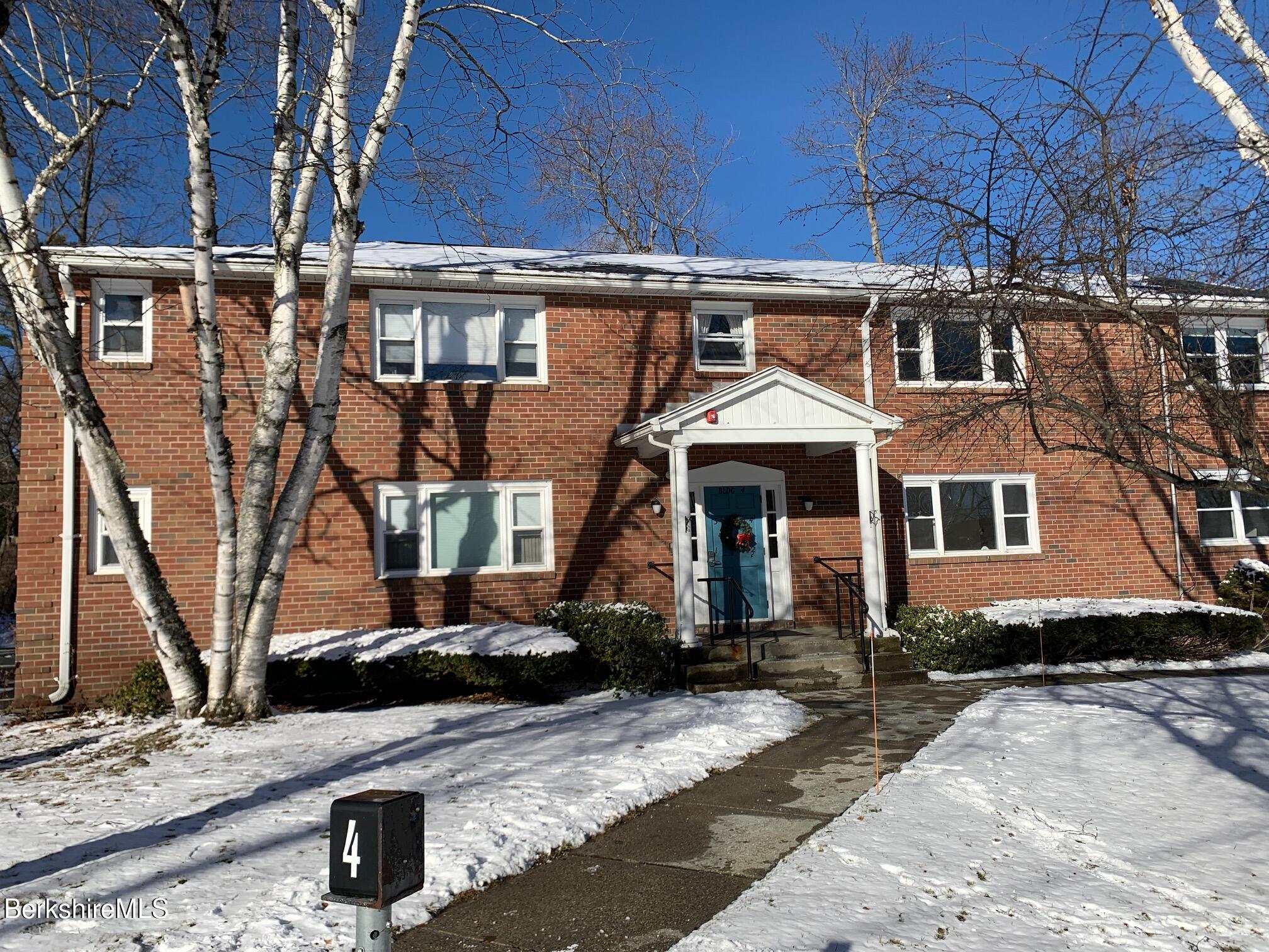 4 Morgan Manor, Unit 4 Lenox, MA 01240 - Photo 1 of 15 a front view of a house with a yard