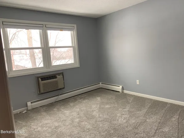 an empty room with a fireplace
