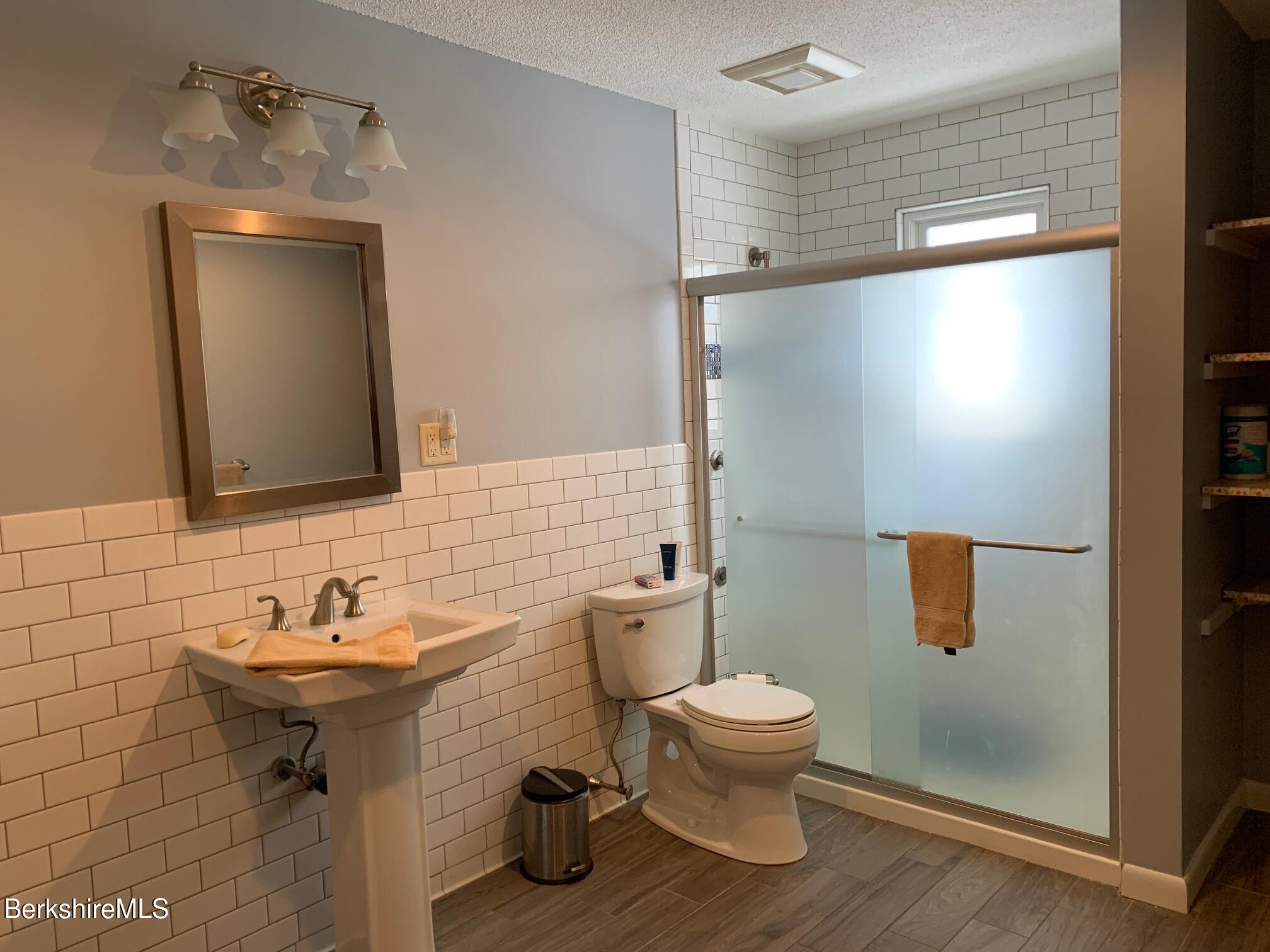 4 Morgan Manor, Unit 4 Lenox, MA 01240 - Photo 13 of 14 a bathroom with a sink toilet and mirror