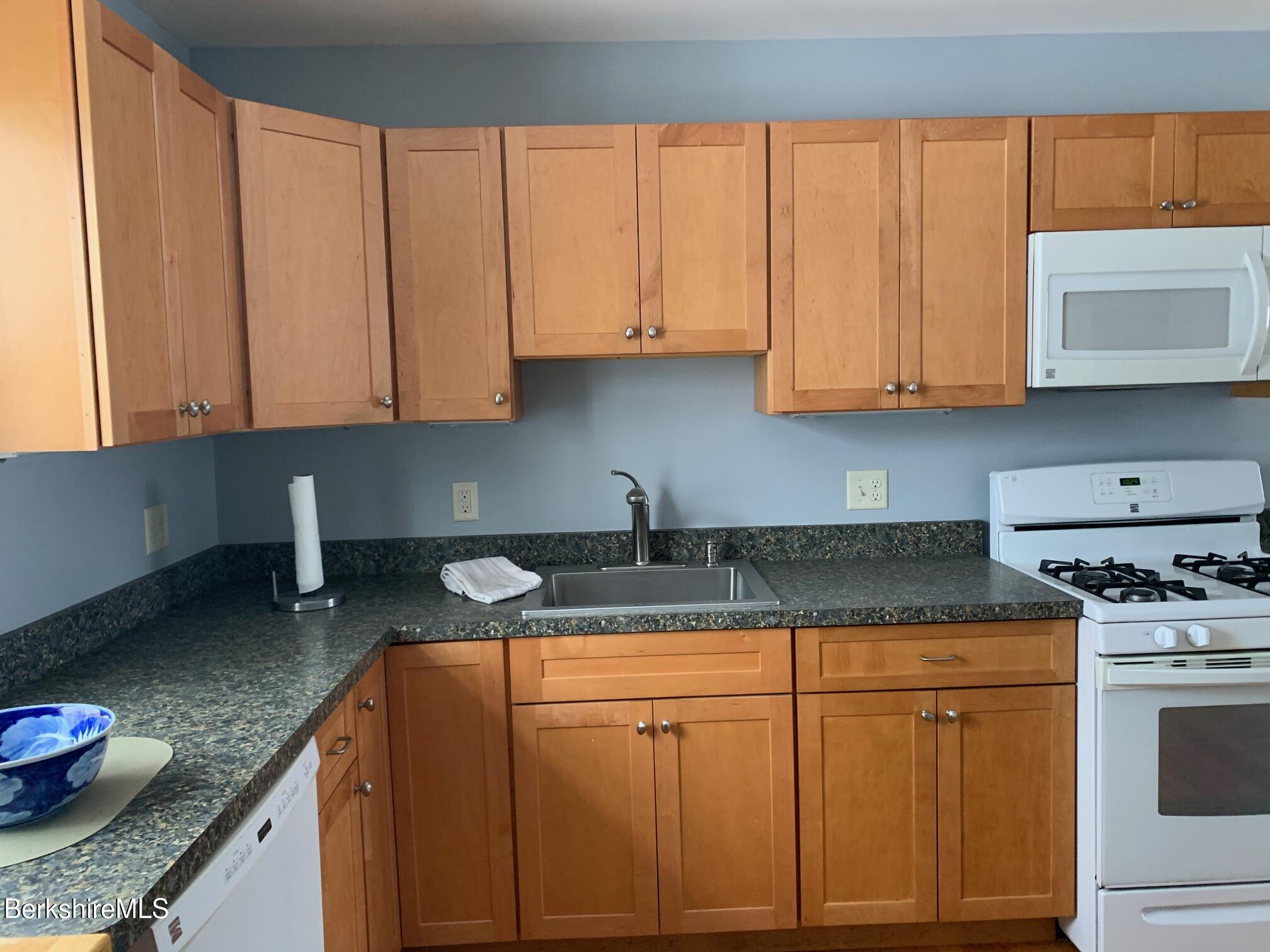 4 Morgan Manor, Unit 4 Lenox, MA 01240 - Photo 9 of 15 a kitchen with granite countertop a sink a stove and cabinets