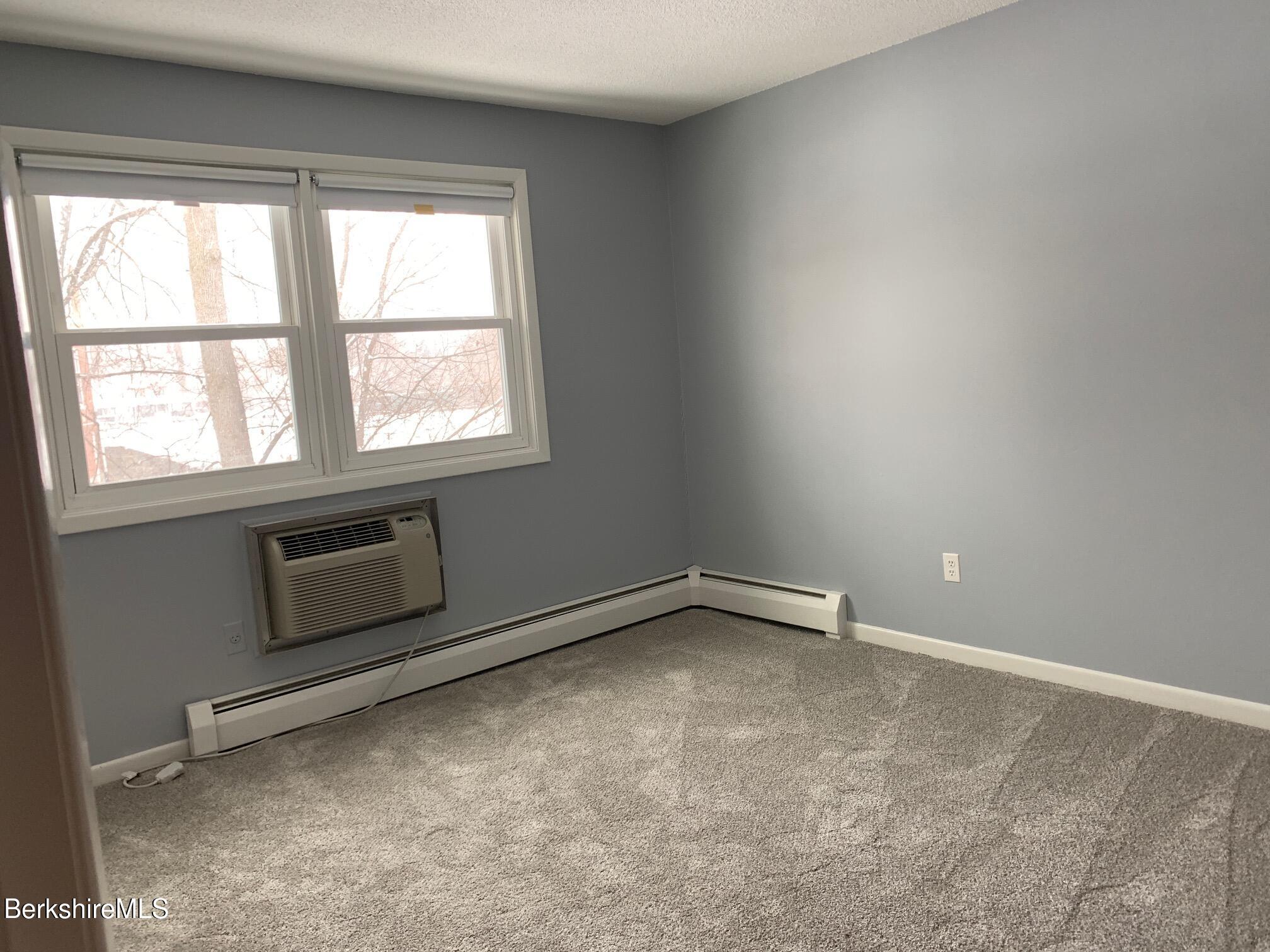 4 Morgan Manor, Unit 4 Lenox, MA 01240 - Photo 10 of 14 an empty room with a fireplace