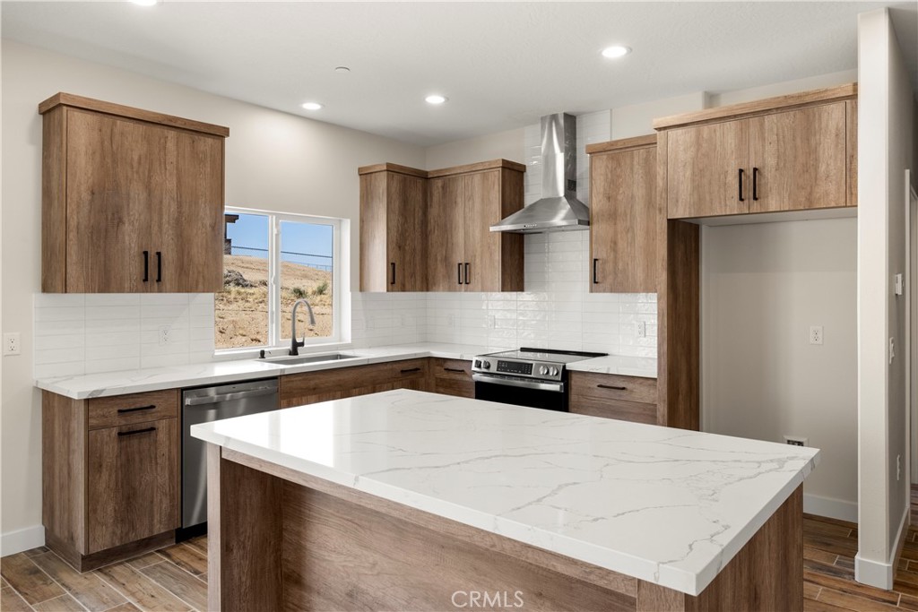 22324 Rancho Street Apple Valley, CA 92308 - Photo 16 of 47 a kitchen with a sink a stove and refrigerator