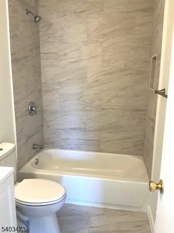 a bathroom with a bathtub and a toilet
