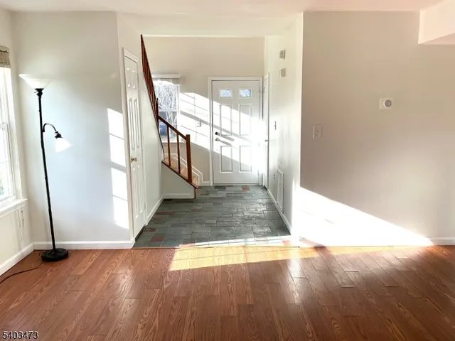 a view of a hallway view with wooden floor and staircase