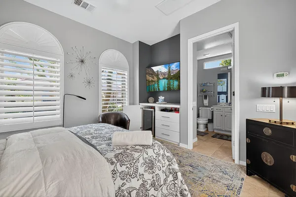 a bedroom with a large bed and a window