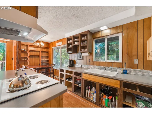 a kitchen with a sink and large window