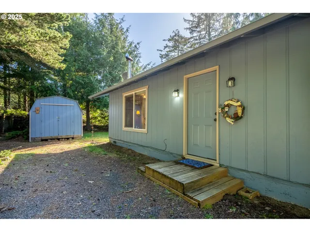 a backyard of a house with barbeque oven table and chairs
