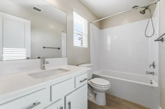 a bathroom with a sink a toilet and a bathtub