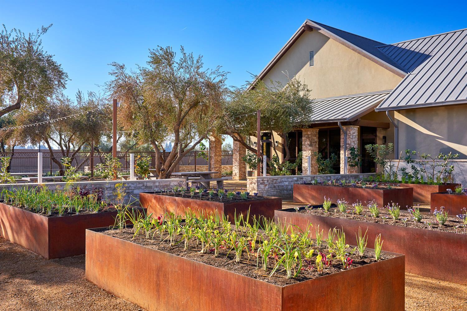 1116 Elevations Way West Madera, CA 93636 - Photo 33 of 35 a view of a white house with a yard and sitting area