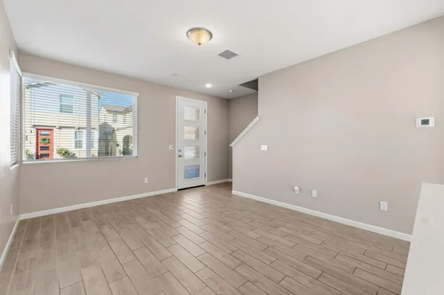 wooden floor in an empty room with a window