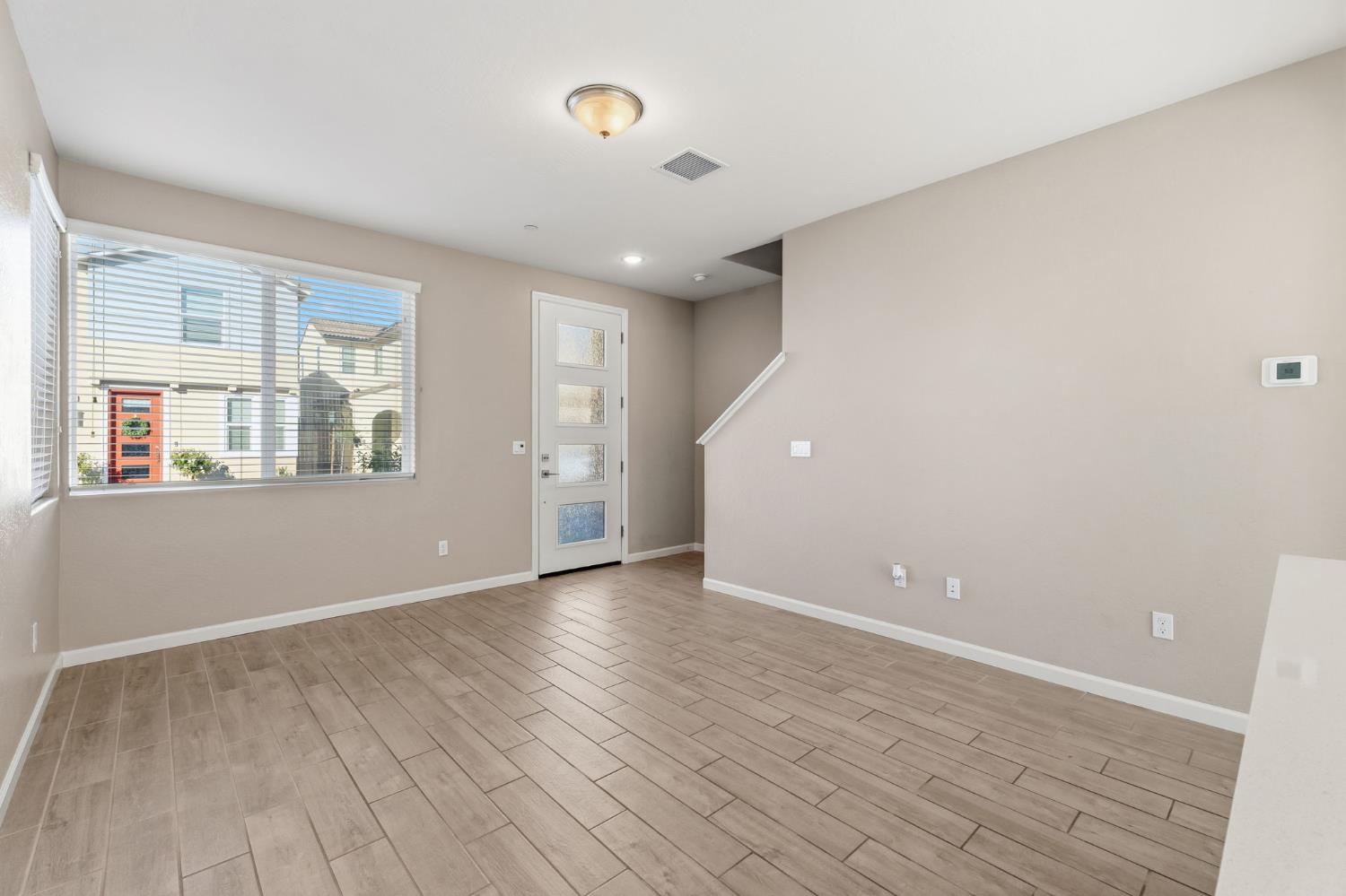 1116 Elevations Way West Madera, CA 93636 - Photo 5 of 35 wooden floor in an empty room with a window