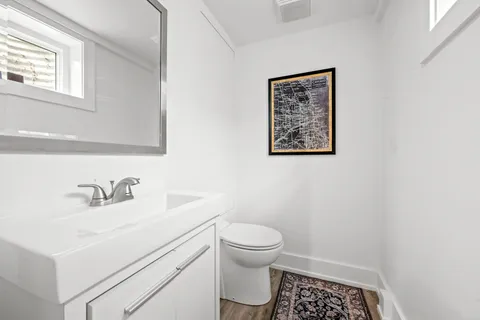a bathroom with a sink a toilet and a mirror