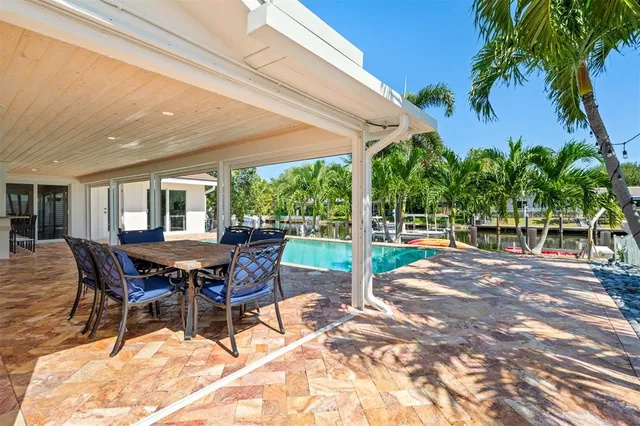 a view of a patio with a table chairs and a backyard