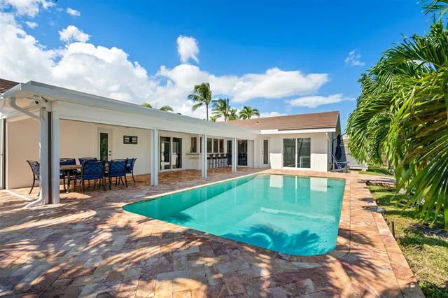 a view of a house with backyard porch and sitting area