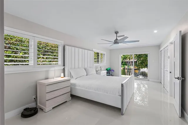 a living room with a bed furniture and a large window