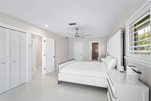 a bedroom with a large bed and a chandelier