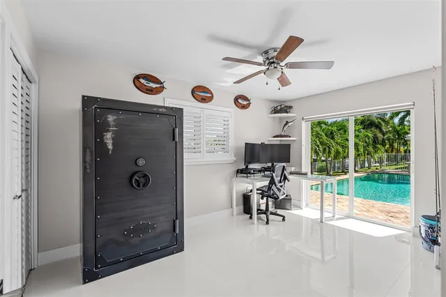 a view of a livingroom with a flat screen tv and a window