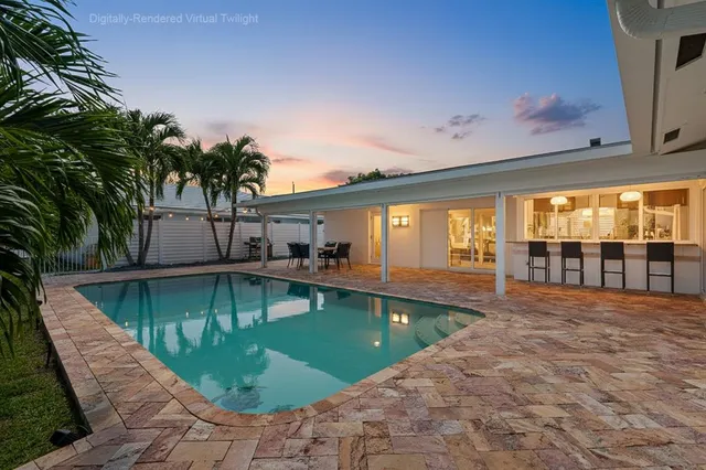swimming pool view with a garden space