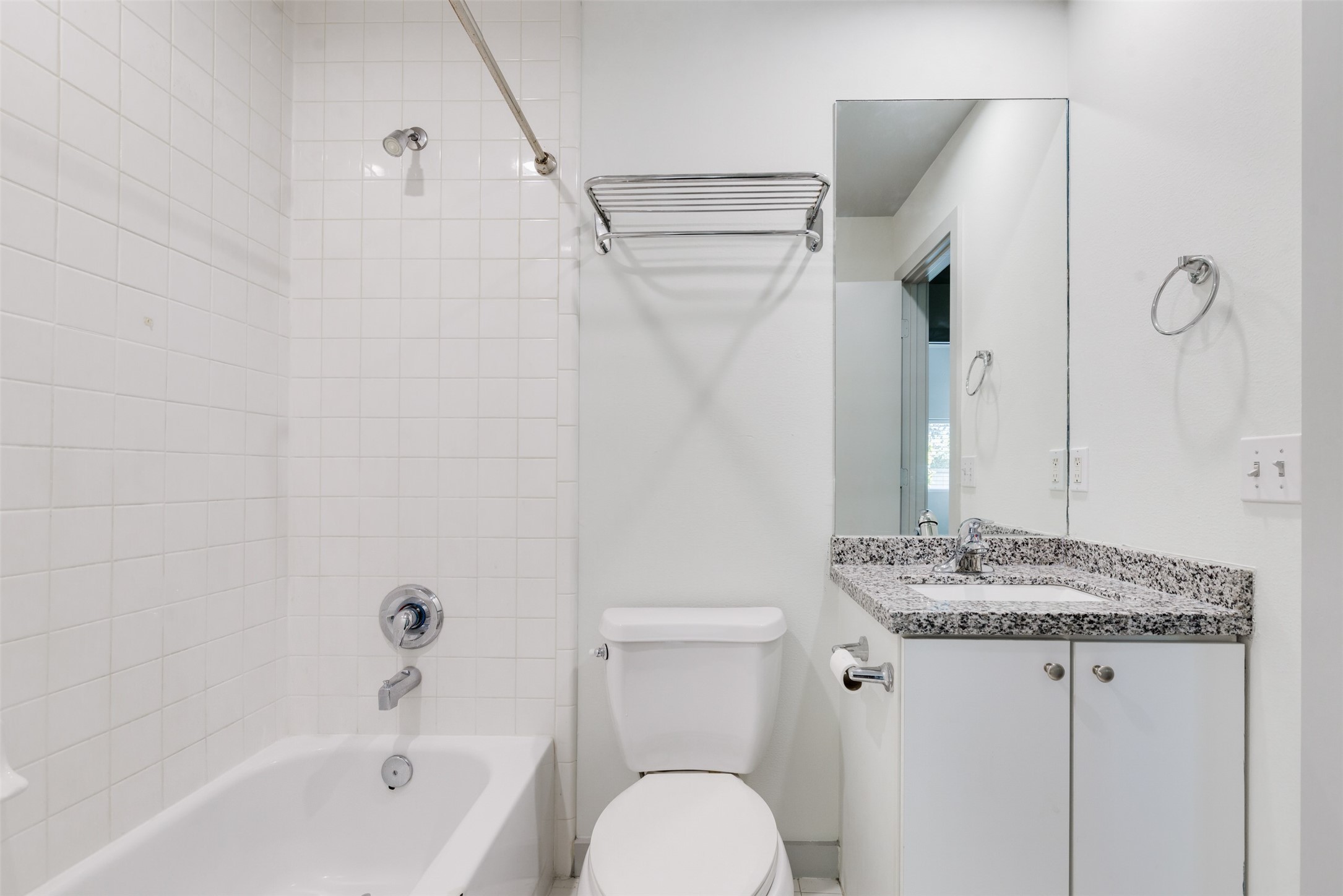 2605 Calumet Street, Unit 48 Houston, TX 77004 - Photo 13 of 34 a bathroom with a granite countertop sink toilet and shower