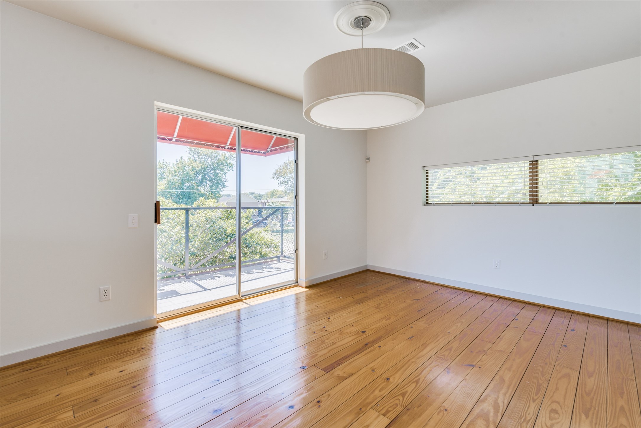 2605 Calumet Street, Unit 48 Houston, TX 77004 - Photo 17 of 34 a view of an empty room with wooden floor and a window