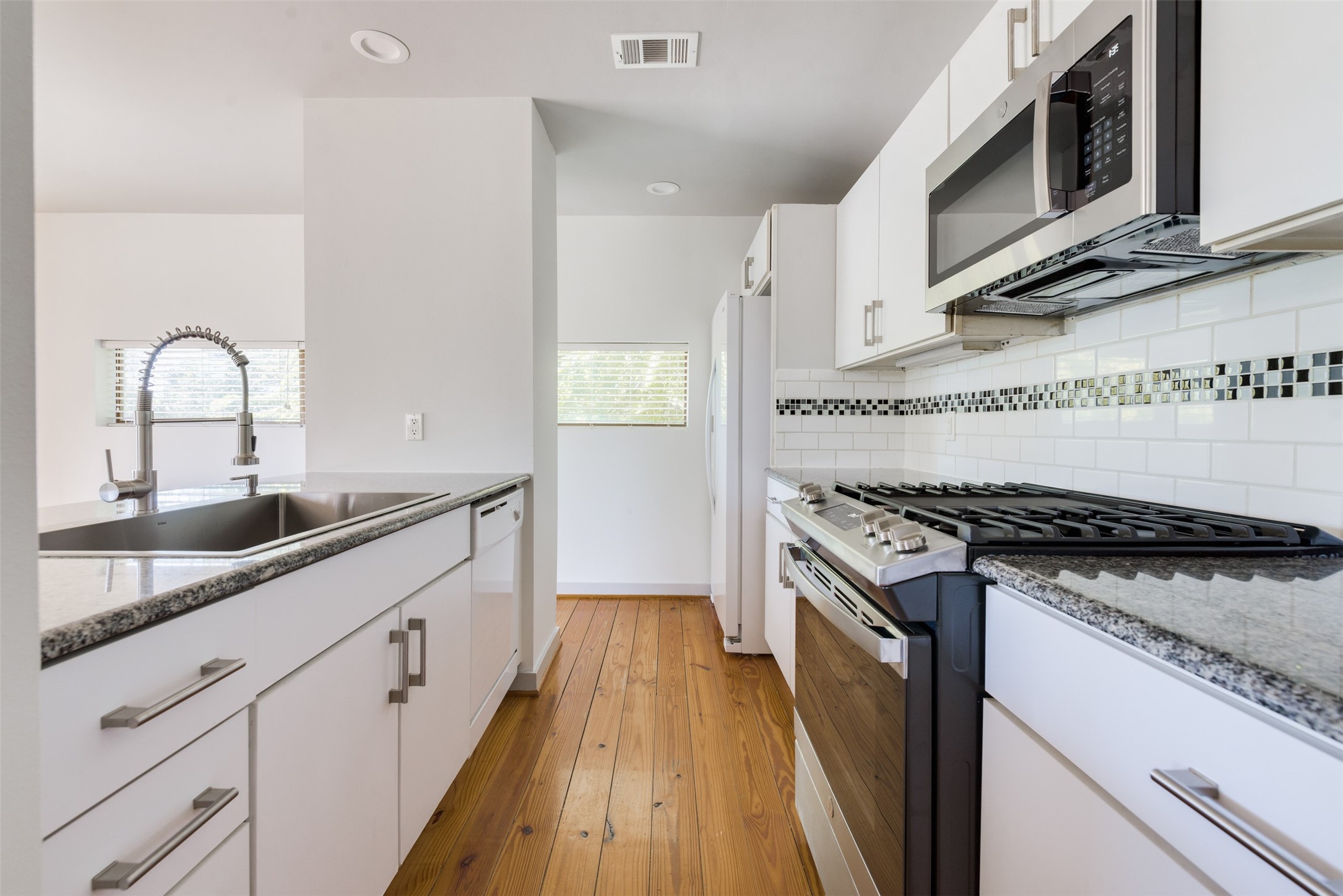 2605 Calumet Street, Unit 48 Houston, TX 77004 - Photo 19 of 34 a kitchen with granite countertop a stove and a sink