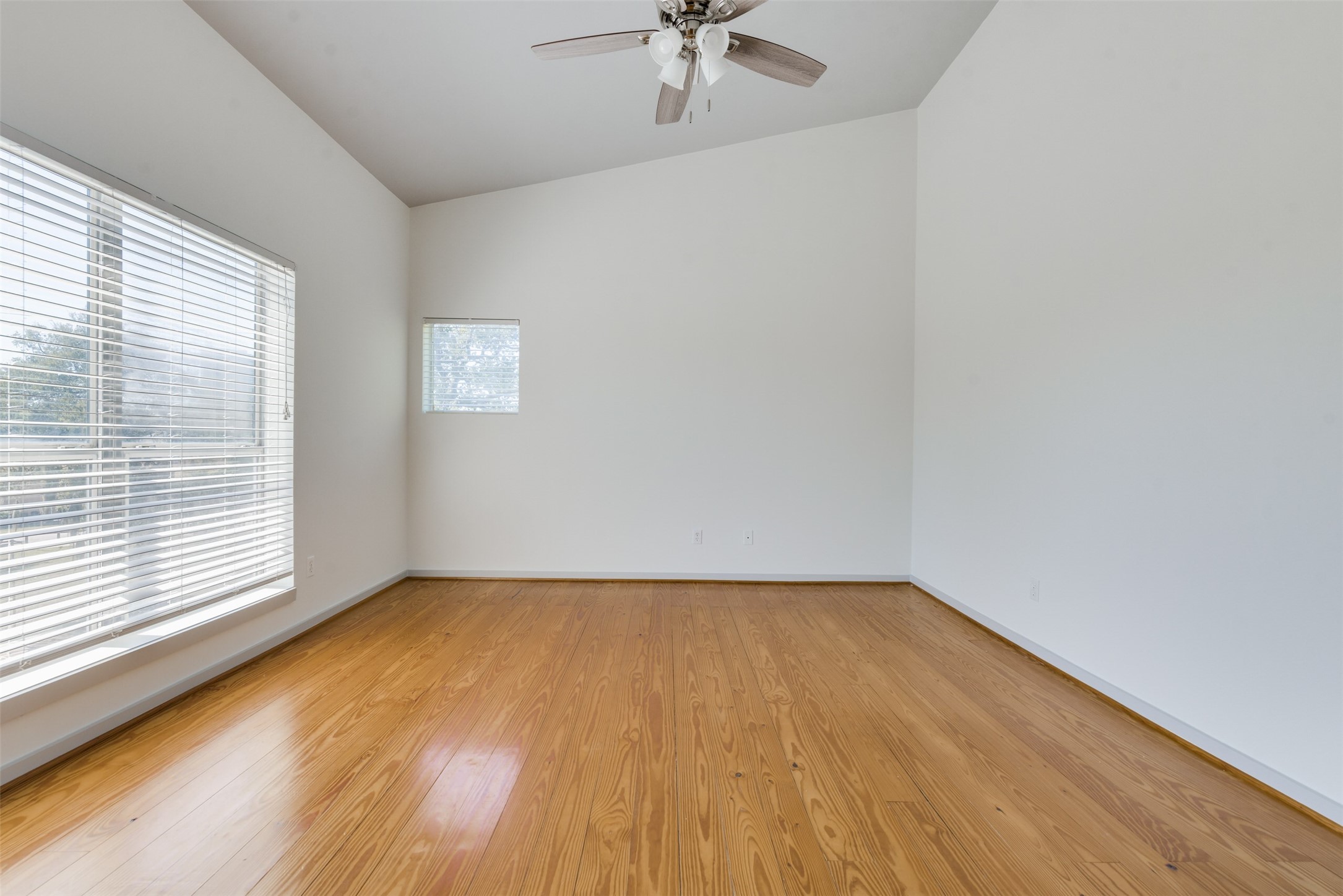 2605 Calumet Street, Unit 48 Houston, TX 77004 - Photo 28 of 34 wooden floor in an empty room with a window