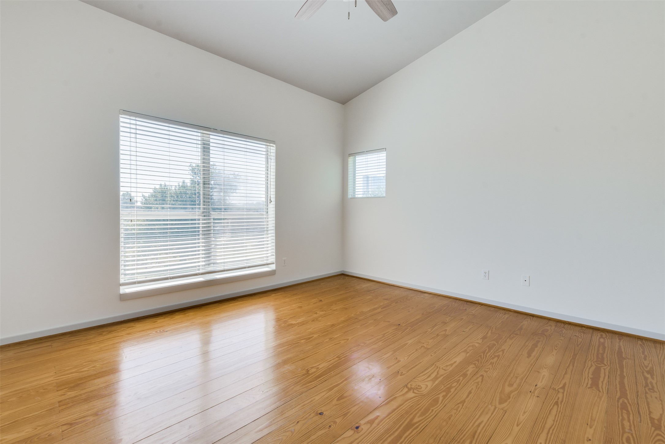 2605 Calumet Street, Unit 48 Houston, TX 77004 - Photo 29 of 34 a view of an empty room with wooden floor and a window